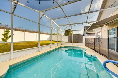 a swimming pool in a building with a glass ceiling at 8 Mi to Disney Parks Poolside Paradise! in Kissimmee