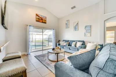 a living room with two blue couches and a table at 8 Mi to Disney Parks Poolside Paradise! in Kissimmee