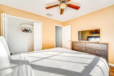 a bedroom with a bed and a ceiling fan at 8 Mi to Disney Parks Poolside Paradise! in Kissimmee