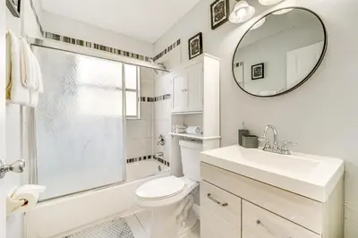 a bathroom with a sink and a toilet and a mirror at 8 Mi to Disney Parks Poolside Paradise! in Kissimmee