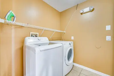 a laundry room with a washer and dryer at 8 Mi to Disney Parks Poolside Paradise! in Kissimmee