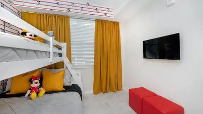 a bedroom with a bunk bed and a television at PXC3180-303 in Kissimmee