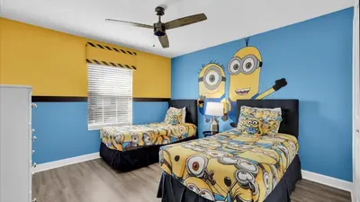 a bedroom with two beds and a yellow and blue wall at GAS3070 in Kissimmee
