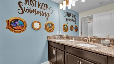 a bathroom with two sinks and a mirror at GAS3070 in Kissimmee