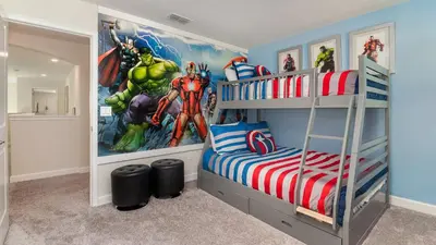 a bedroom with a superhero mural on the wall at KCC 4797 in Kissimmee
