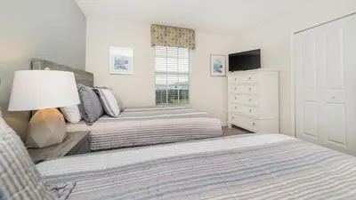 a bedroom with two beds and a dresser at KCC4749 in Kissimmee