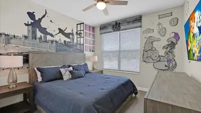 a bedroom with a bed with a blue comforter at PLW4277 in Kissimmee