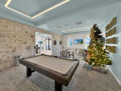 a pool table in a room with a christmas tree at QTS4361 in Kissimmee