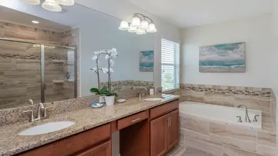 a bathroom with two sinks and a tub and a shower at KCC4741 in Kissimmee