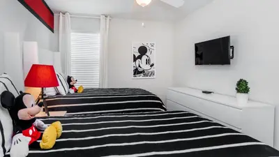 a bedroom with two beds and a flat screen tv at KCC4741 in Kissimmee