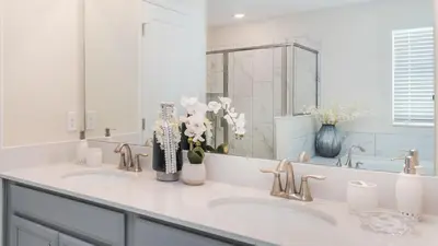 a white bathroom with two sinks and a mirror at NRL4543 in Kissimmee