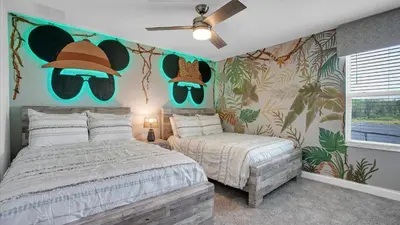 a bedroom with a bed and a hat and glasses on the wall at PGD4169 in Kissimmee