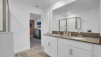 a white bathroom with two sinks and a mirror at PGD4169 in Kissimmee