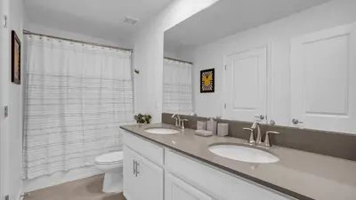a white bathroom with two sinks and a toilet at PGD4169 in Kissimmee