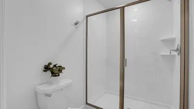 a bathroom with a glass shower with a toilet at PGD4169 in Kissimmee