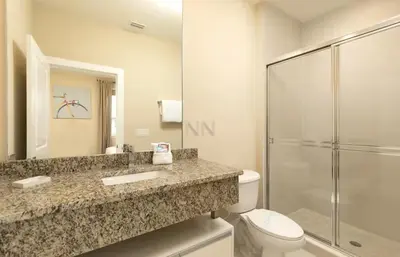 a bathroom with a shower and a toilet and a sink at Magical & Spacious Home Minutes from Disney Parks in Orlando