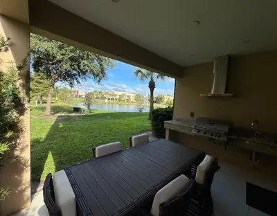 a kitchen with a table and a view of a yard at Magical & Spacious Home Minutes from Disney Parks in Orlando