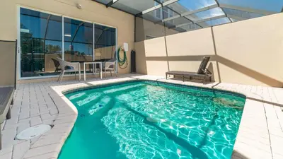a swimming pool with a table and chairs in a house at Windsor Hills 3 Bedroom Private Pool Townhome 0857 in Orlando