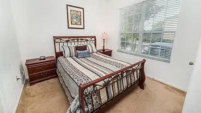 a bedroom with a bed and a window at Windsor Hills 3 Bedroom Private Pool Townhome 0865 in Orlando