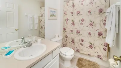 a bathroom with a sink and a toilet and a shower curtain at Windsor Hills 3 Bedroom Private Pool Townhome 0865 in Orlando