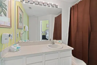 a bathroom with a sink and a large mirror at Windsor Hills 3 Bedroom Private Pool Townhome 0866 in Orlando