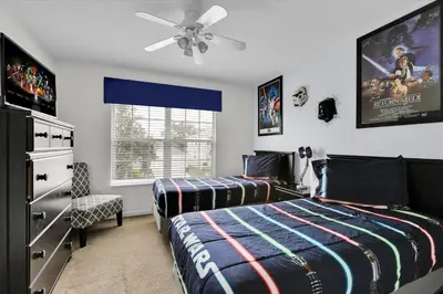 a bedroom with two beds and a ceiling fan at Windsor Hills Resort 5 Bedroom Updated Pool Home 0853 in Orlando