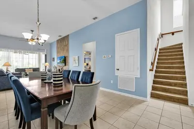a dining room and living room with a table and chairs at Windsor Hills Resort 5 Bedroom Updated Pool Home 0853 in Orlando