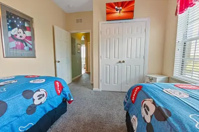 a bedroom with two beds and a blue comforter at Windsor Hills Resort 3 Bedroom 4th Floor Condo with Resort Access 0946 in Orlando