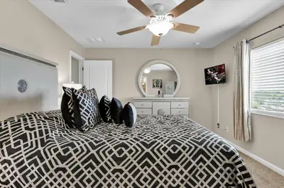 a bedroom with a bed with a ceiling fan at Windsor Hills Resort 6 Bedroom Private Pool Spa Home 0743 in Orlando