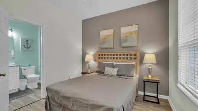 a bedroom with a bed and a toilet and two lamps at Windsor Hills Resort 3 Bedroom Private Pool Townhome 0876 in Orlando