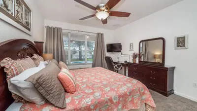 a bedroom with a bed and a dresser and a mirror at Windsor Hills Resort 5 Bedroom Home with Game Room 0851 in Orlando