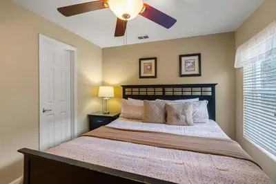 a bedroom with a bed with a ceiling fan at Windsor Hills Resort 5 Bedroom Private Pool Home 0869 in Orlando