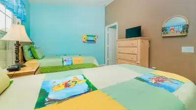 a bedroom with two beds and a dresser and a mirror at Windsor Palms Resort 3 Bedroom Pool Townhome 0868 in Kissimmee
