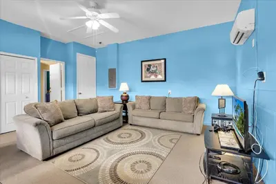 a living room with two couches and a blue wall at Windsor Palms Resort 4 Bedroom with Game Room 0878 in Kissimmee