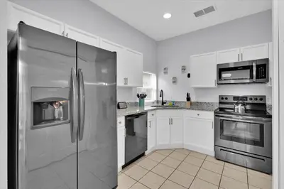 a kitchen with a stainless steel refrigerator and appliances at Windsor Palms Resort 4 Bedroom with Game Room 0882 in Kissimmee