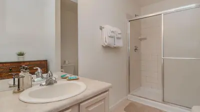 a white bathroom with a sink and a shower at Windsor Palms Resort 6 Bedroom with Game Room 0847 in Kissimmee