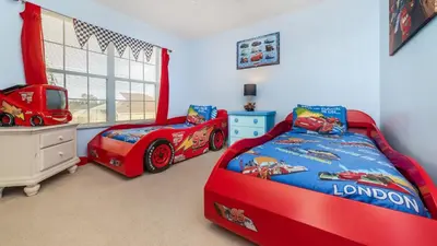 two beds in a room with a red race car at Windsor Palms Resort 6 Bedroom with Game Room 0847 in Kissimmee