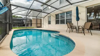 a large swimming pool with a table and chairs at Windsor Palms Resort 6 Bedroom with Game Room 0847 in Kissimmee