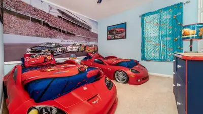 a room with three red race cars on the wall at Windsor Palms Resort 6 Bedroom with Pool Spa 0877 in Kissimmee