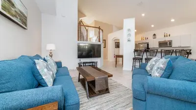 a living room with two blue couches and a tv at Windsor Palms Resort 6 Bedroom with Pool Spa 0877 in Kissimmee