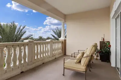 a balcony with a white railing and a chair at AQ0401 Villas North Charm in Orlando