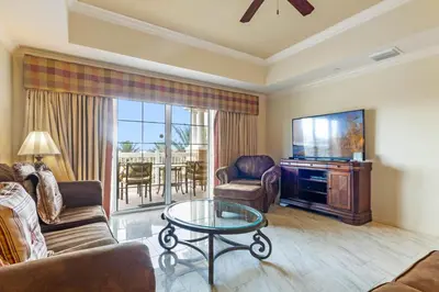 a living room with a couch and a tv and a table at AQ0401 Villas North Charm in Orlando