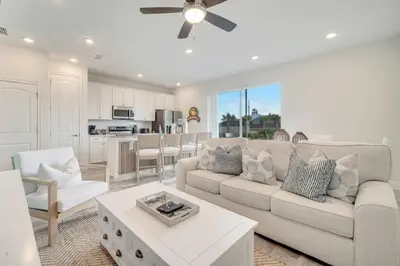 a white living room with a couch and a table at Just Lauched - Luxury & Cozy 3BR near Disney-Margaritaville in Orlando