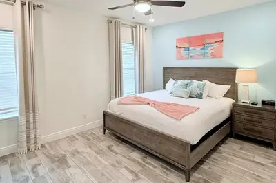 a bedroom with a bed and a ceiling fan at Just Lauched - Luxury & Cozy 3BR near Disney-Margaritaville in Orlando