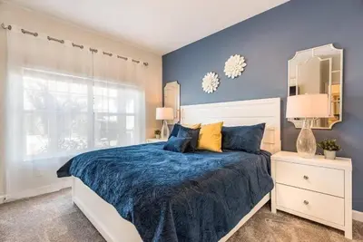 a bedroom with a bed and a blue wall at casa 4Q com piscina Mickey & Star Wars! in Kissimmee