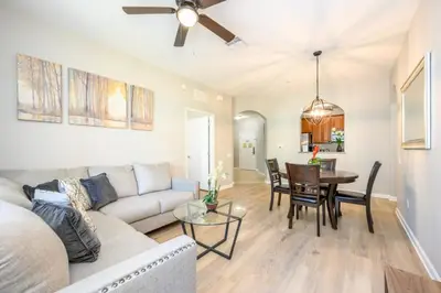 a living room with a couch and a table at Epic Universe Deluxe Condo, Vista Cay - 3002 in Orlando