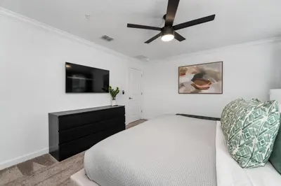 a bedroom with a bed and a ceiling fan at Family Mickey & Star Wars - FREE Heated Pool in Kissimmee