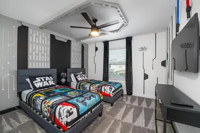 a bedroom with two beds and a ceiling fan at Family Mickey & Star Wars - FREE Heated Pool in Kissimmee