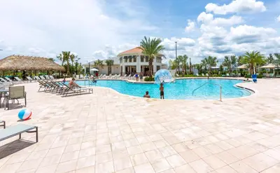 a pool at a resort with people playing in it at Villa Kerpen - Storey Lake in Kissimmee