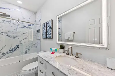 a bathroom with a sink and a toilet and a mirror at 5014 Tideview Circle 9 in Orlando